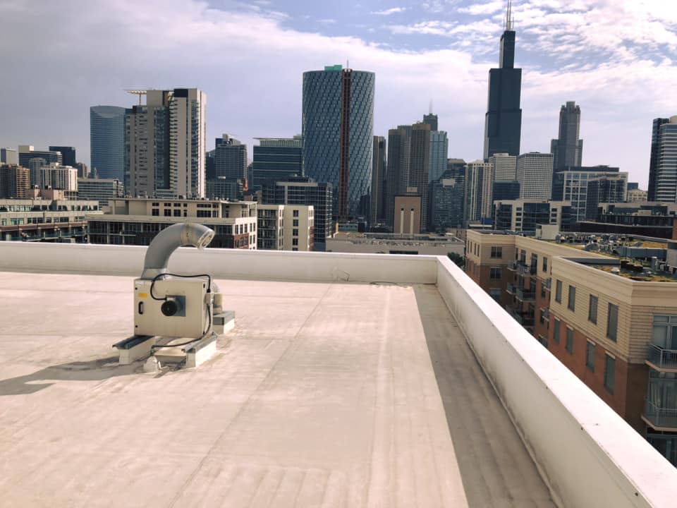 Commercial Roof in downtown urban area against skyline